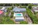An aerial view showcasing the house, pool and storage shed at 7341 Hart St, Englewood, FL 34224