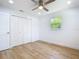 Bright bedroom with modern ceiling fan, wood floors, and double door closet at 7341 Hart St, Englewood, FL 34224