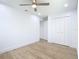 Clean bedroom with light wood floors, closet, and ceiling fan at 7341 Hart St, Englewood, FL 34224