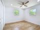 Bedroom featuring wood floors, modern ceiling fan, and windows at 7341 Hart St, Englewood, FL 34224