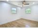 Well lit bedroom has ceiling fan and light wood flooring at 7341 Hart St, Englewood, FL 34224