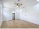 Spacious bedroom with light wood floors, ceiling fan, and closet at 7341 Hart St, Englewood, FL 34224