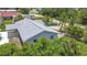 An exterior view of a light blue single-Gathering home with a brand new roof in a sunny neighborhood at 7341 Hart St, Englewood, FL 34224