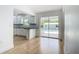 Open concept kitchen featuring white cabinets and black countertops with sliding door to outdoor pool at 7341 Hart St, Englewood, FL 34224