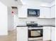 Bright kitchen boasts white cabinets, black countertops, and stainless steel appliances at 7341 Hart St, Englewood, FL 34224
