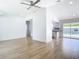 Spacious living room with a ceiling fan and seamless access to the modern kitchen at 7341 Hart St, Englewood, FL 34224