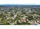 A wide aerial view of a dense residential neighborhood with tree-lined streets on a sunny day at 7341 Hart St, Englewood, FL 34224
