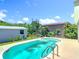 Backyard pool featuring a large lounge area and mature landscaping providing a relaxing outdoor space at 7341 Hart St, Englewood, FL 34224