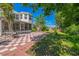 A well sized backyard featuring a checkerboard patio, a screen enclosure, and partially fenced yard at 7716 Nottinghill Sky Dr, Apollo Beach, FL 33572