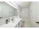 Bright bathroom featuring a white vanity with a large mirror and a combined tub and shower at 7716 Nottinghill Sky Dr, Apollo Beach, FL 33572
