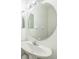 Clean, well-lit bathroom with a white sink and a round mirror at 7716 Nottinghill Sky Dr, Apollo Beach, FL 33572