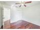 Cozy bedroom with hardwood floors, closet, and ceiling fan at 7716 Nottinghill Sky Dr, Apollo Beach, FL 33572