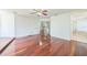 Spacious bedroom with gleaming hardwood floors, ceiling fan, and access to bathroom at 7716 Nottinghill Sky Dr, Apollo Beach, FL 33572