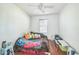 Cozy bedroom featuring hardwood floors and a window at 7716 Nottinghill Sky Dr, Apollo Beach, FL 33572