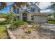 Two-story home with attractive landscaping and a manicured front yard at 7716 Nottinghill Sky Dr, Apollo Beach, FL 33572