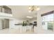 Bright kitchen features white cabinetry, granite countertops, and stainless steel appliances at 7716 Nottinghill Sky Dr, Apollo Beach, FL 33572