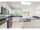 Bright kitchen with stainless steel appliances, an island, and granite countertops at 7716 Nottinghill Sky Dr, Apollo Beach, FL 33572