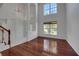 Spacious living room with hardwood floors, staircase, and large windows at 7716 Nottinghill Sky Dr, Apollo Beach, FL 33572