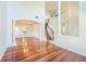 Open-concept living space featuring hardwood floors, elegant columns, and staircase at 7716 Nottinghill Sky Dr, Apollo Beach, FL 33572