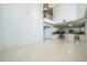 Spacious open-concept living room and kitchen area with tile floors and natural light at 7716 Nottinghill Sky Dr, Apollo Beach, FL 33572