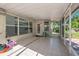 A well sized screened in porch with tile flooring and entry to the grassy backyard at 7716 Nottinghill Sky Dr, Apollo Beach, FL 33572