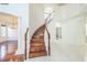 Elegant staircase with wooden steps and white railing leading to the upper level at 7716 Nottinghill Sky Dr, Apollo Beach, FL 33572