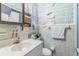 Small bathroom with decorative green wallpaper and standard sink and toilet at 8490 7Th Ln N,, St Petersburg, FL 33702