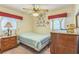 Cozy bedroom with ceiling fan, carpet, and decorative touches at 8490 7Th Ln N,, St Petersburg, FL 33702