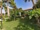 Landscaped backyard with blooming flowers and tropical greenery; sunny day at 1244 E Corktree Cir, Port Charlotte, FL 33952