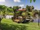 Backyard view showcasing a wooden deck and a peaceful pond at 1244 E Corktree Cir, Port Charlotte, FL 33952