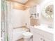 Bright bathroom featuring a shower and tub combination, vanity, and storage shelves at 1244 E Corktree Cir, Port Charlotte, FL 33952