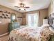 A bright bedroom with a ceiling fan, curtains, and a door to the exterior patio at 1244 E Corktree Cir, Port Charlotte, FL 33952