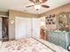 Bedroom with a ceiling fan, closet space, and an ensuite bathroom for added convenience at 1244 E Corktree Cir, Port Charlotte, FL 33952