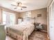 Comfortable bedroom with wood-look floors, a ceiling fan and access to an outdoor patio at 1244 E Corktree Cir, Port Charlotte, FL 33952