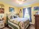 Well-lit bedroom with a ceiling fan, curtains, and a window, offering a tranquil space at 1244 E Corktree Cir, Port Charlotte, FL 33952