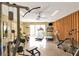 Brightly lit fitness room offering treadmill, weight machines, fan and tv at 1244 E Corktree Cir, Port Charlotte, FL 33952