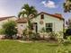 Cozy single-story home with tidy front yard featuring mature landscaping and unique decorative accents at 1244 E Corktree Cir, Port Charlotte, FL 33952