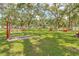 Multiple horseshoe pits, offering community recreational activities, set amid mature trees and green spaces at 1244 E Corktree Cir, Port Charlotte, FL 33952