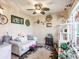 Comfortable living room with custom decorations, including a ceiling fan and eclectic wall art at 1244 E Corktree Cir, Port Charlotte, FL 33952