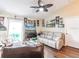 Bright living room with a ceiling fan, ample natural light, and comfortable furnishings at 1244 E Corktree Cir, Port Charlotte, FL 33952