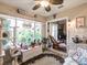Bright sunroom with a ceiling fan, lots of plants, and views of the outdoor scenery at 1244 E Corktree Cir, Port Charlotte, FL 33952