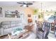 Open-concept living area with vaulted ceilings, ceiling fan, and stylish, comfortable furniture at 1244 E Corktree Cir, Port Charlotte, FL 33952