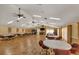 Large meeting room with wood floors, tables, chairs and flat screen tv at 1244 E Corktree Cir, Port Charlotte, FL 33952