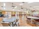 Large meeting room featuring hardwood floors, multiple tables, and natural light from sliding glass doors at 1244 E Corktree Cir, Port Charlotte, FL 33952