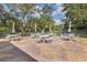 Outdoor patio with tables and chairs, perfect for relaxing and socializing in a serene setting at 1244 E Corktree Cir, Port Charlotte, FL 33952