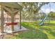 Community playground with a swing set and slide, next to a picnic shelter, offering a fun outdoor space at 1244 E Corktree Cir, Port Charlotte, FL 33952