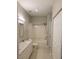 Full bathroom with shower and tub, complete with a double granite vanity at 4307 Bayside Village Dr # 103, Tampa, FL 33615
