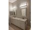 Bright bathroom featuring a double granite vanity with modern lighting and tile floor at 4307 Bayside Village Dr # 103, Tampa, FL 33615