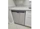 Whirlpool stainless steel dishwasher with white cabinets and granite counters at 4307 Bayside Village Dr # 103, Tampa, FL 33615