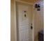 Front door of unit with door knob and knocker and wall-mounted light at 4307 Bayside Village Dr # 103, Tampa, FL 33615